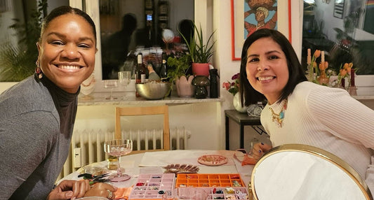 Two friends smiling at Pamabela's first necklace-making workshop in Darmstadt