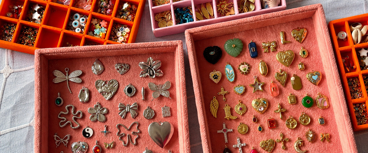 Pink velvet trays with silver and gold charms for building your own Only Yours piece